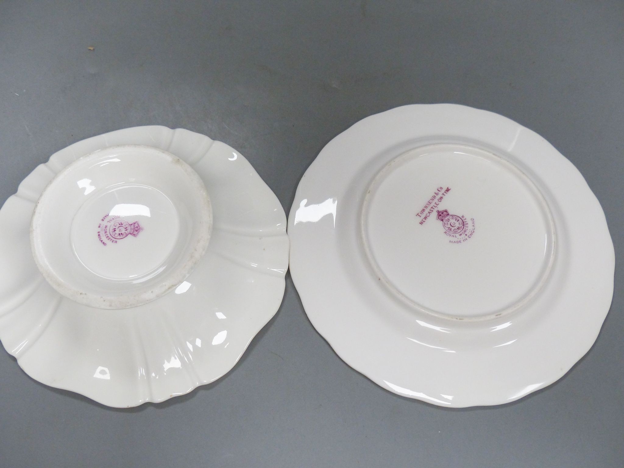 A Royal Worcester fruit painted pedestal dish signed A Shuck and a similar plate signed E Barnes, early 20th century, 14.3 and 16cm